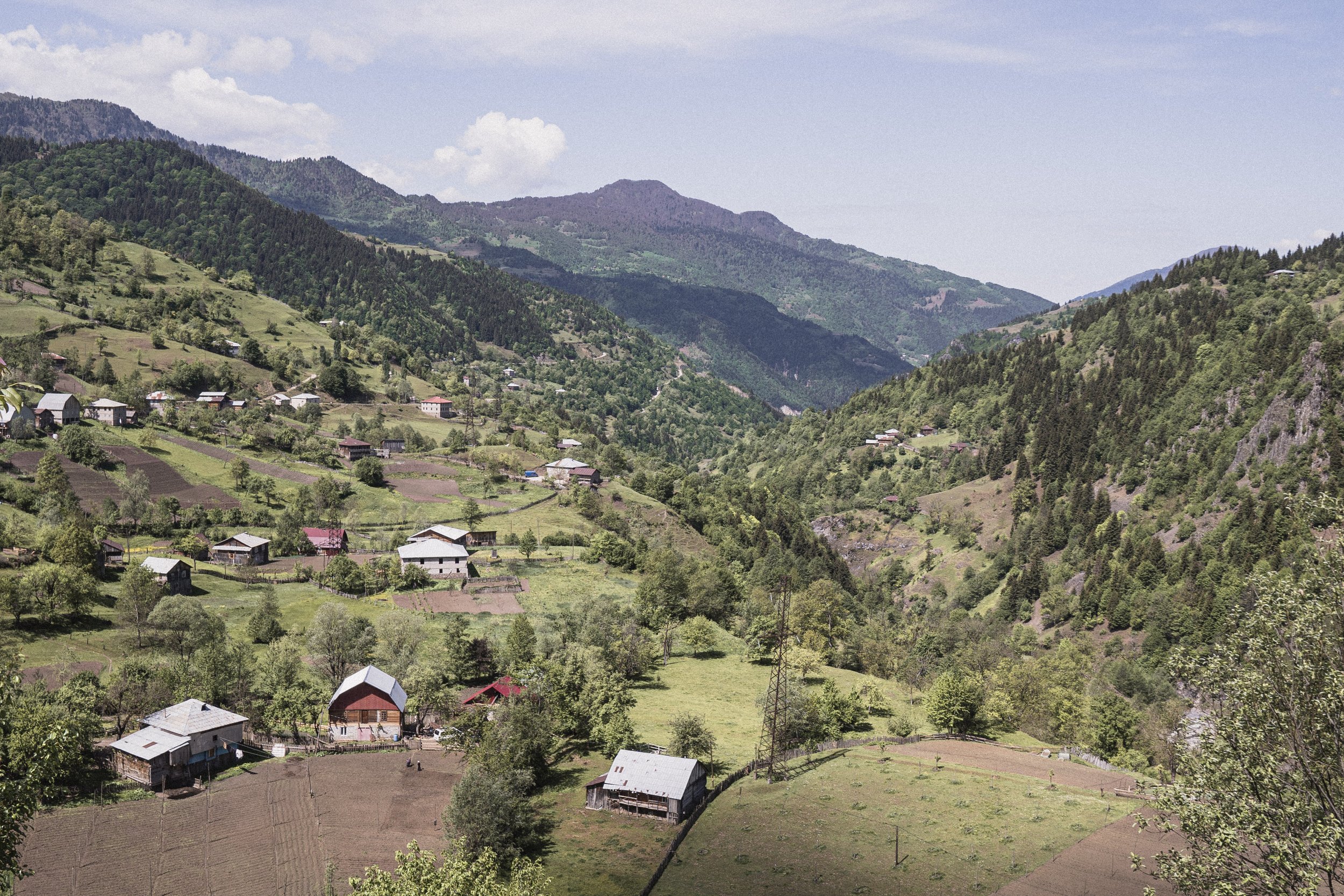 Mountainous Landscape with Villages in Upper Adjara Aerial view of a mountainous landscape featuring several small villages and green fields in Upper Adjara