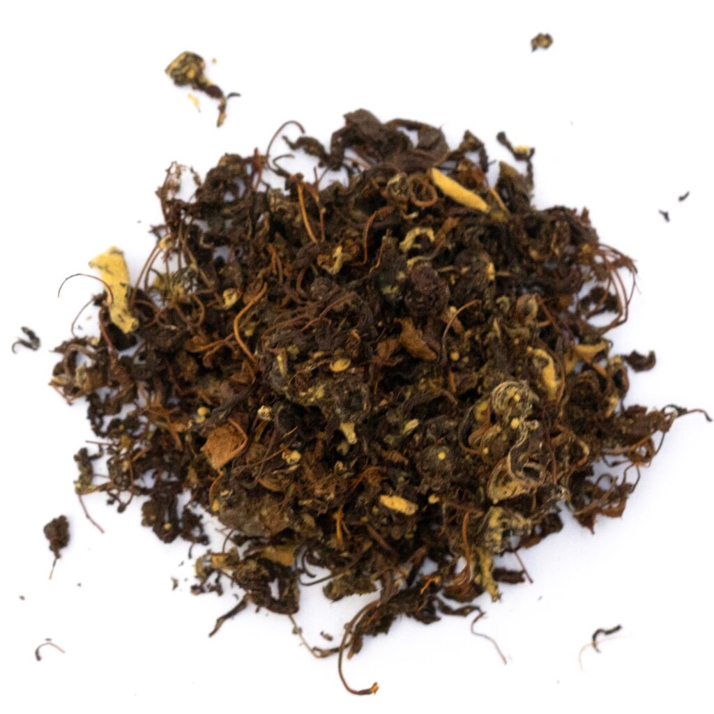 A pile of loose apple tea leaves with various shades of brown and yellow pieces.