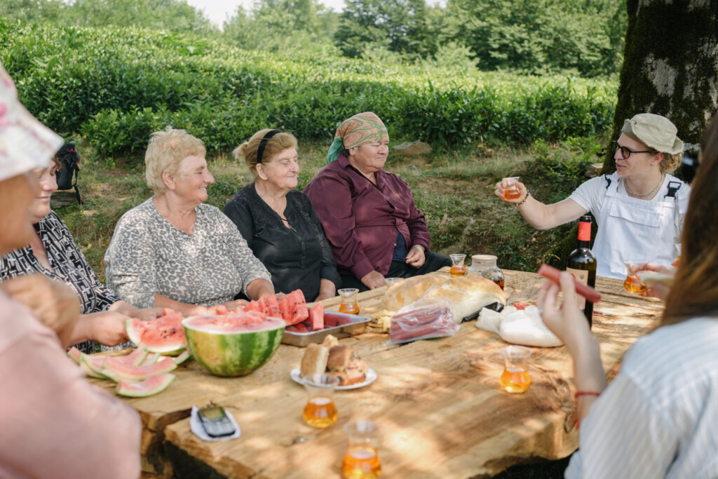 Georgii leads a tea supra with the tea pluckers